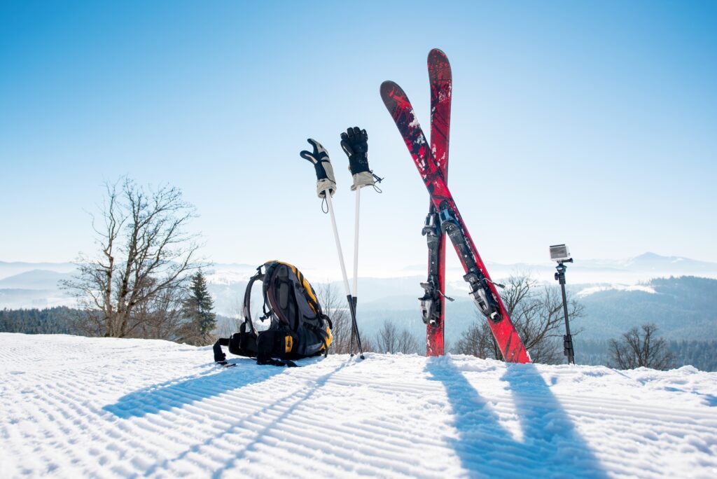 Skis skiing poles and backpack on the mountain